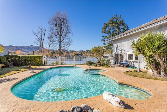 view of swimming pool featuring a patio area and a mountain view