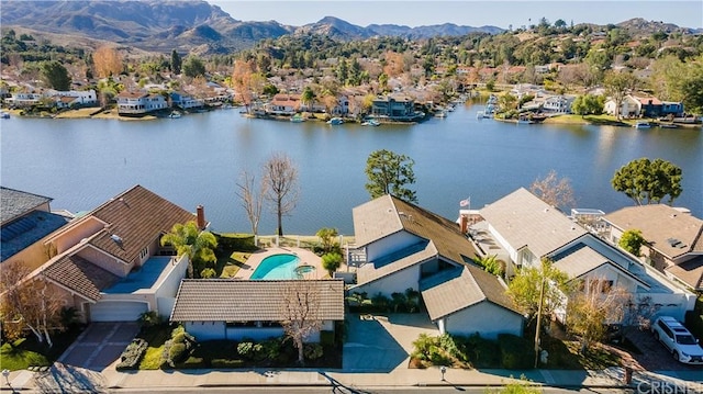 drone / aerial view with a water and mountain view