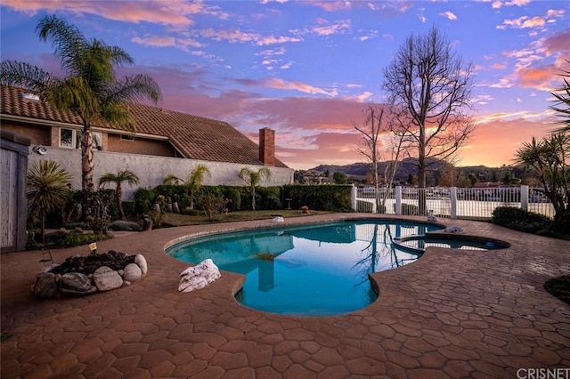 pool at dusk with a patio