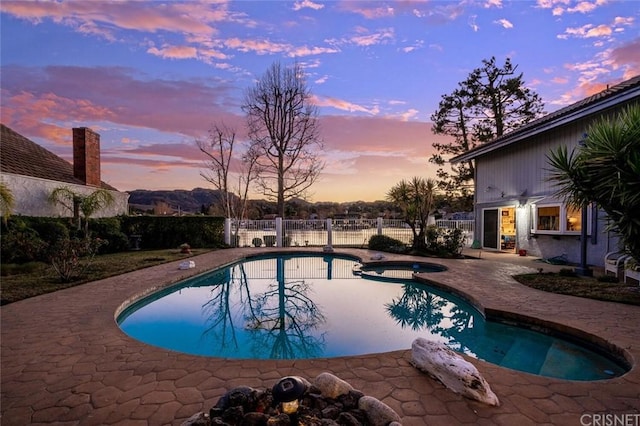 pool at dusk with a patio