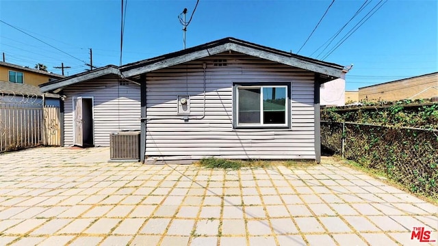 back of property featuring central AC and a patio