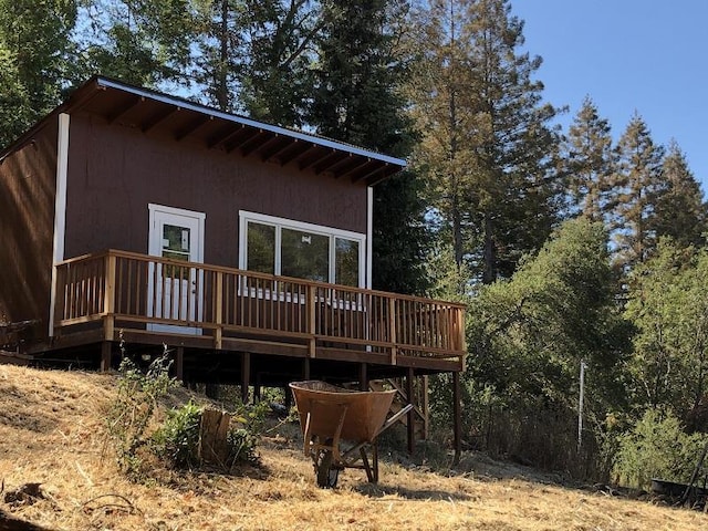 rear view of property with a wooden deck