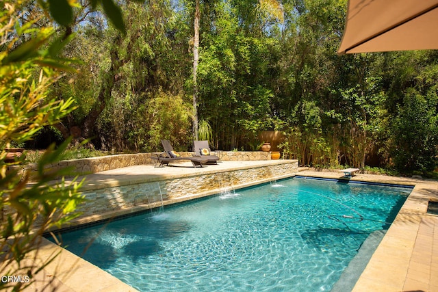 view of pool featuring pool water feature and a patio area