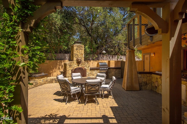 view of patio featuring an outdoor kitchen and a grill