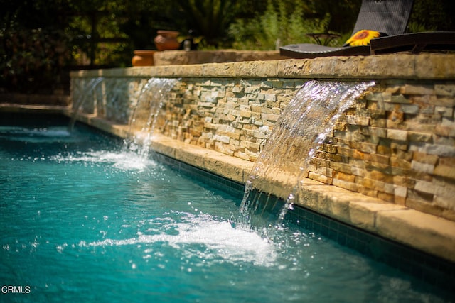 view of pool featuring pool water feature