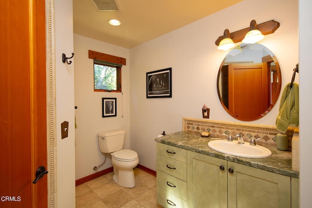 bathroom featuring vanity, tile floors, and toilet