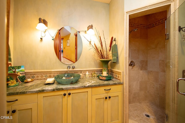 bathroom featuring a tile shower and vanity