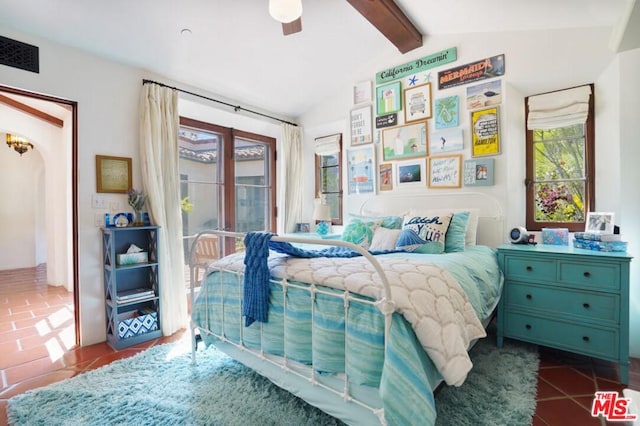 tiled bedroom featuring vaulted ceiling with beams and ceiling fan