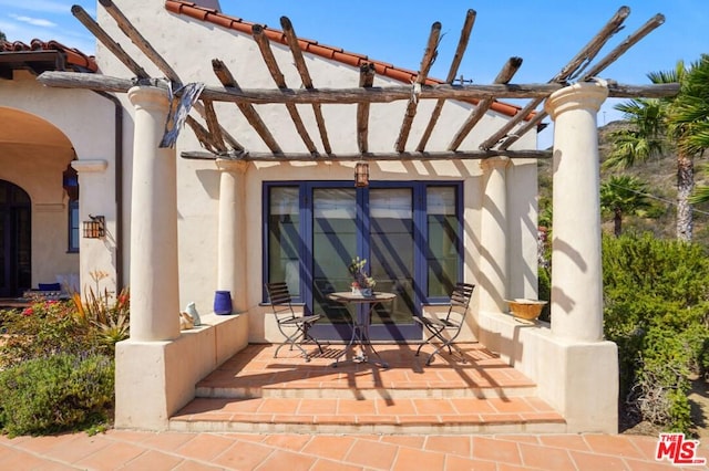 view of patio / terrace featuring a pergola and french doors