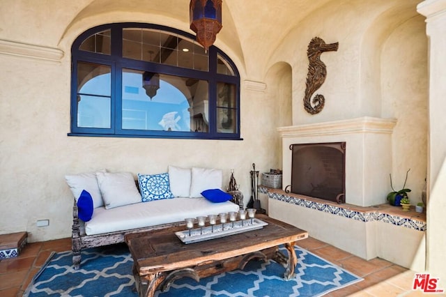 living room with tile flooring and vaulted ceiling