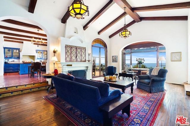 living room with dark hardwood / wood-style flooring, high vaulted ceiling, an inviting chandelier, and beamed ceiling