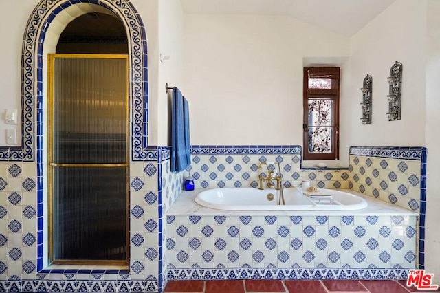 bathroom with vaulted ceiling and plus walk in shower