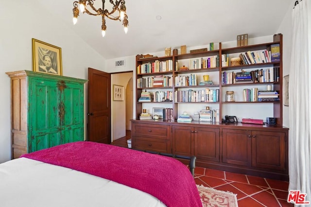 tiled bedroom featuring a chandelier and lofted ceiling