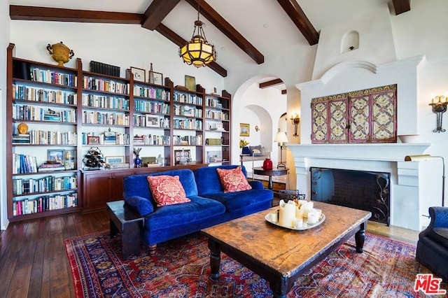 living room featuring high vaulted ceiling, dark hardwood / wood-style floors, beam ceiling, and built in shelves