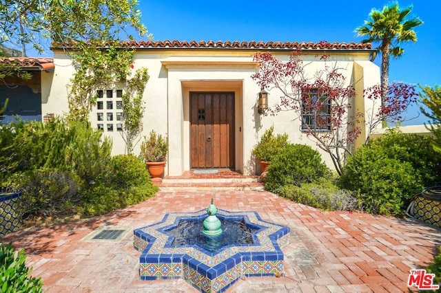 property entrance with a patio