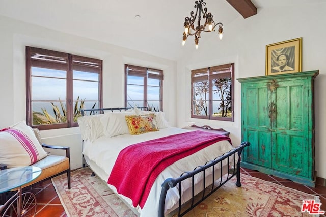 tiled bedroom featuring an inviting chandelier and beam ceiling