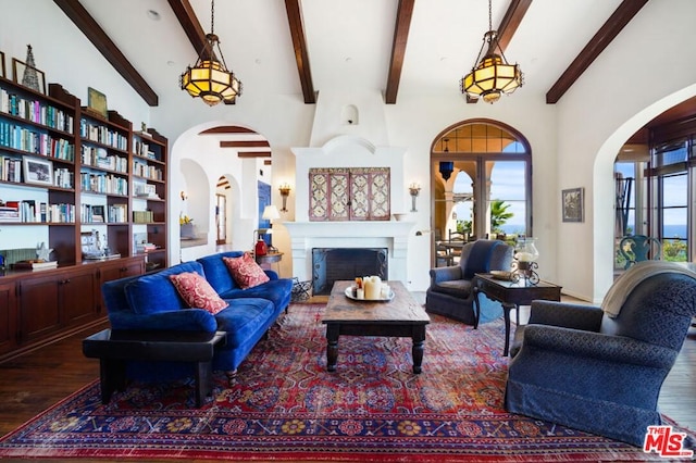 living room with vaulted ceiling with beams and dark hardwood / wood-style floors