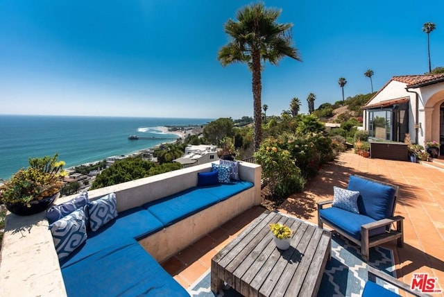 view of patio with a water view and an outdoor living space