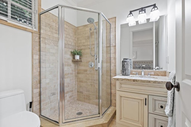 bathroom featuring vanity, a shower with shower door, and toilet