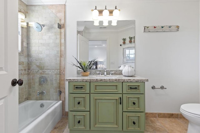 full bathroom with ornamental molding, vanity, tiled shower / bath, and toilet