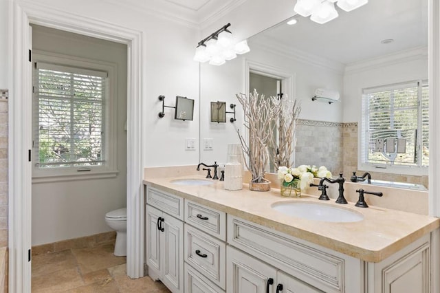 bathroom with ornamental molding, vanity, and toilet