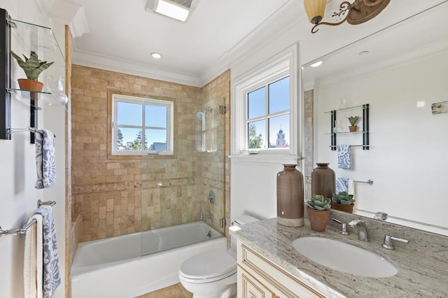 full bathroom with tiled shower / bath, vanity, crown molding, and toilet