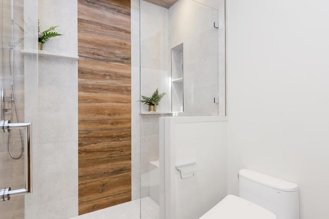 bathroom with walk in shower, wood walls, and toilet