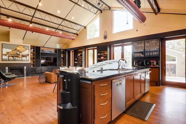 kitchen with an island with sink, a wealth of natural light, dishwasher, and sink