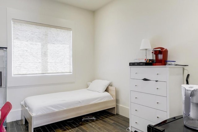 bedroom with dark hardwood / wood-style flooring