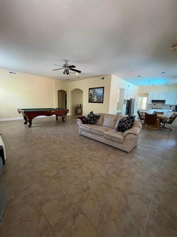 living room with light tile floors, billiards, and ceiling fan