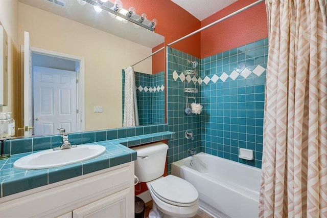 full bathroom with shower / tub combo with curtain, vanity with extensive cabinet space, and toilet