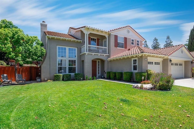 mediterranean / spanish house featuring a balcony, a front lawn, and a garage