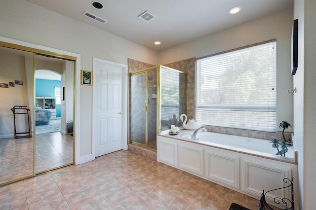 bathroom featuring separate shower and tub and tile floors