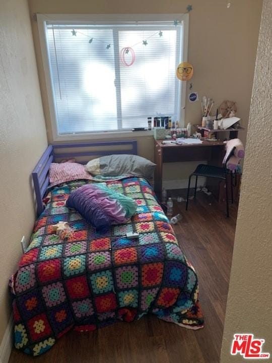 bedroom with dark wood-type flooring