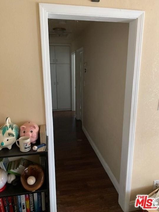 corridor featuring dark wood-type flooring