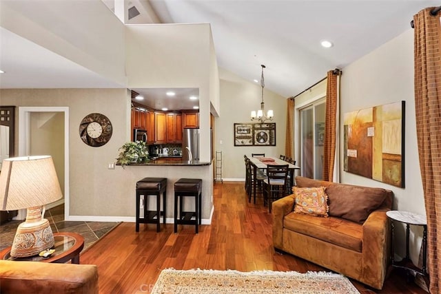 living room featuring a notable chandelier, high vaulted ceiling, and dark hardwood / wood-style floors