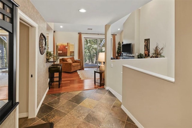 hallway with dark tile floors