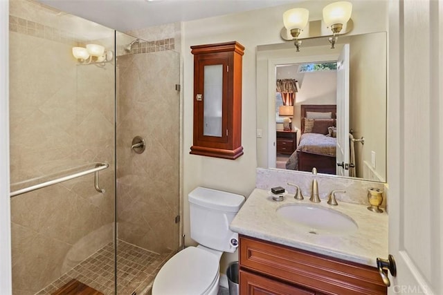 bathroom featuring toilet, walk in shower, and vanity