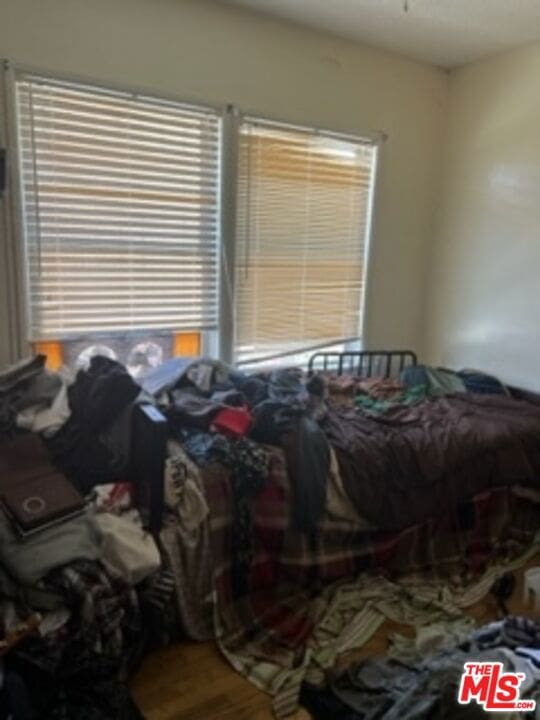 bedroom featuring multiple windows and hardwood / wood-style floors