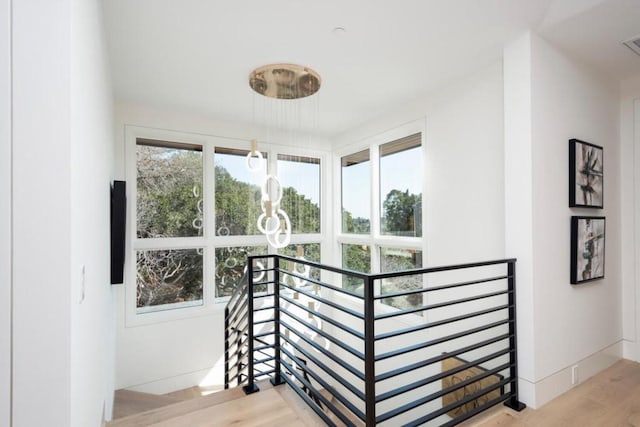 stairway with light wood-type flooring