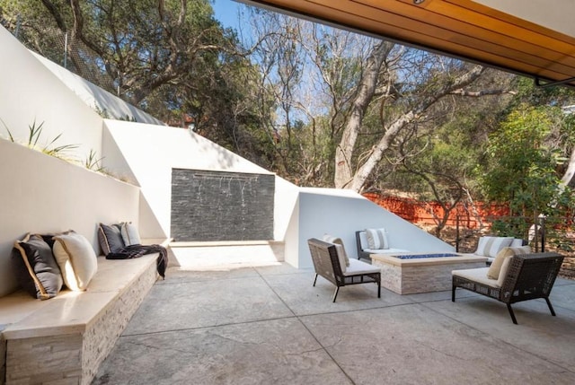 view of patio / terrace with an outdoor living space with a fireplace