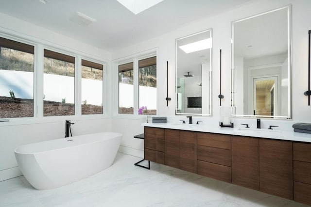 bathroom featuring a bathing tub, double vanity, and tile floors