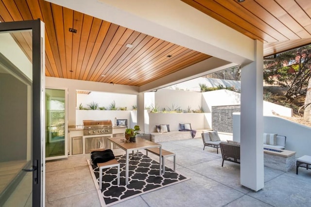 view of terrace with area for grilling, an outdoor kitchen, and an outdoor living space