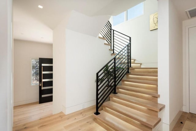 staircase with light hardwood / wood-style floors