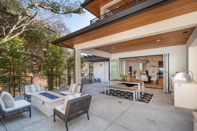 view of patio / terrace featuring an outdoor living space with a fire pit