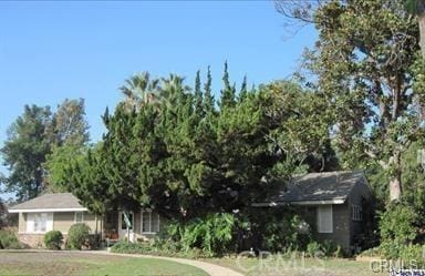 view of property hidden behind natural elements