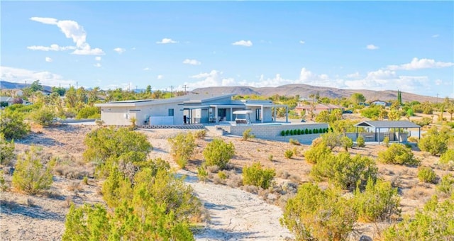 back of property with a mountain view