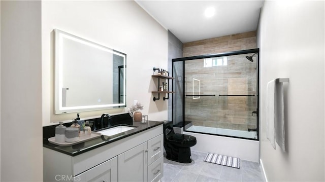 full bathroom featuring shower / bath combination with glass door, tile flooring, vanity, and toilet