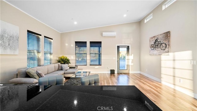 living room with ornamental molding, high vaulted ceiling, an AC wall unit, and hardwood / wood-style flooring