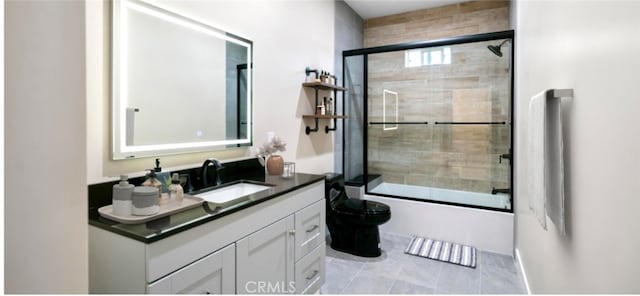 full bathroom featuring toilet, bath / shower combo with glass door, and vanity